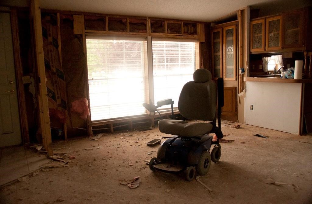 An abandoned wheelchair in a destroyed home. Source: FEMA 